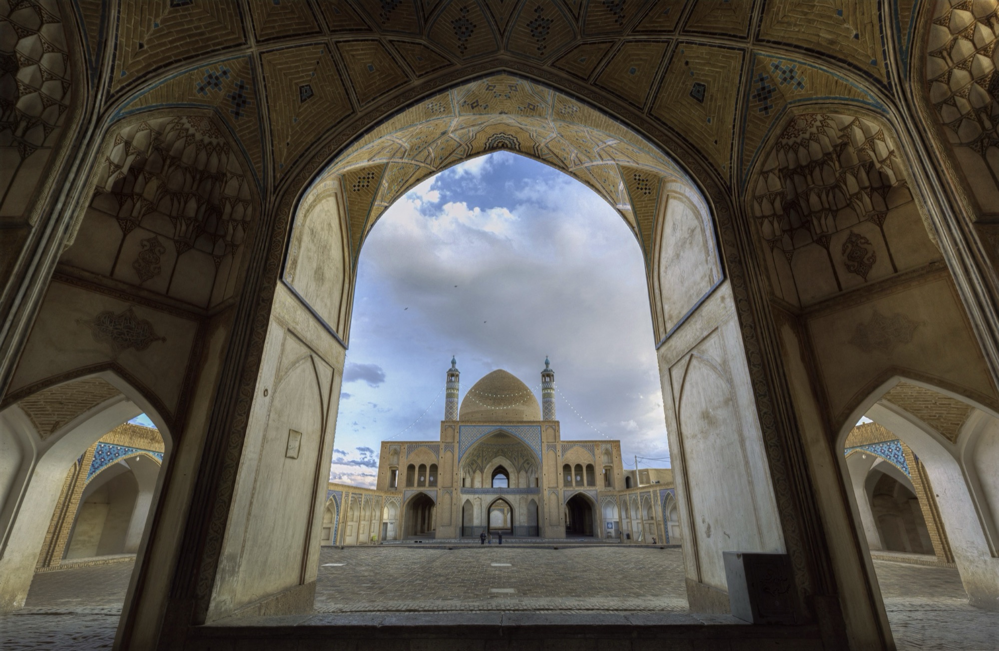 Agha Bozorg Mosque, courtyard framed by a side iwan