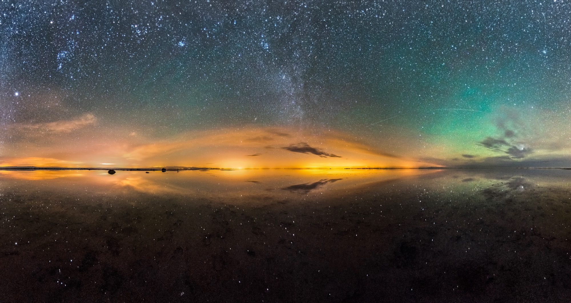 Salt flat mirroring the night sky — probably Maranjab