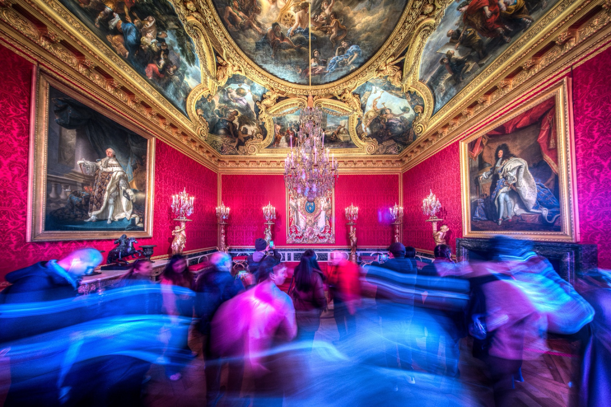 A great French interior photographed in a long exposure: the architecture sharp and still, visitors dissolved into traces of light.