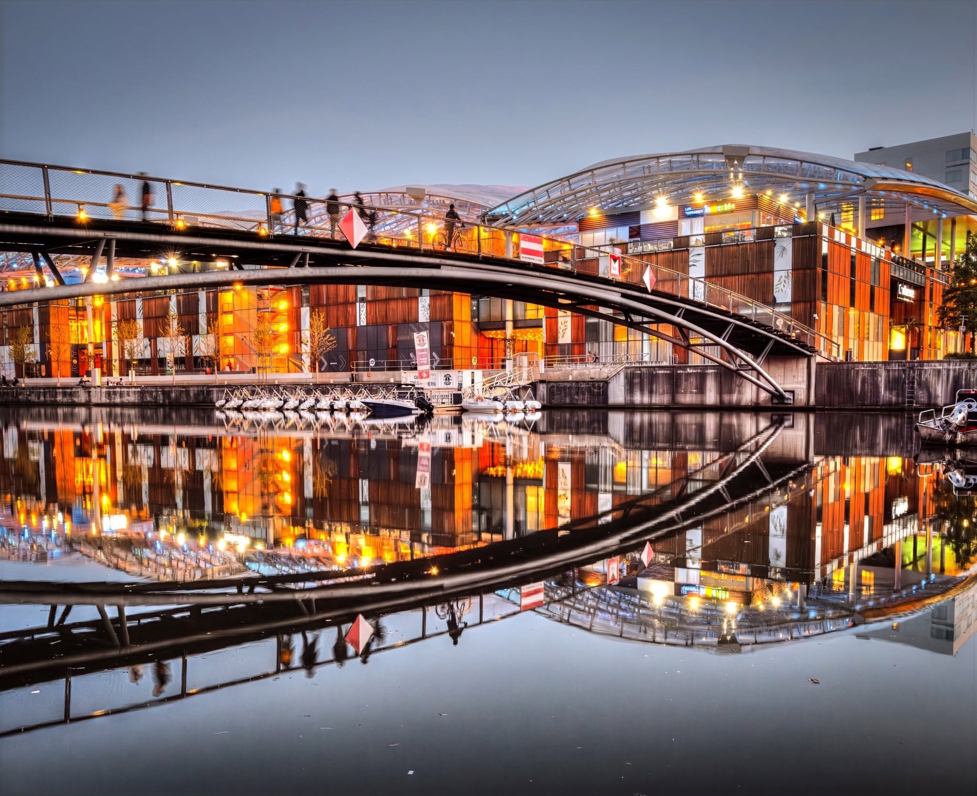Lyon Confluence and its footbridge reflected at dusk
