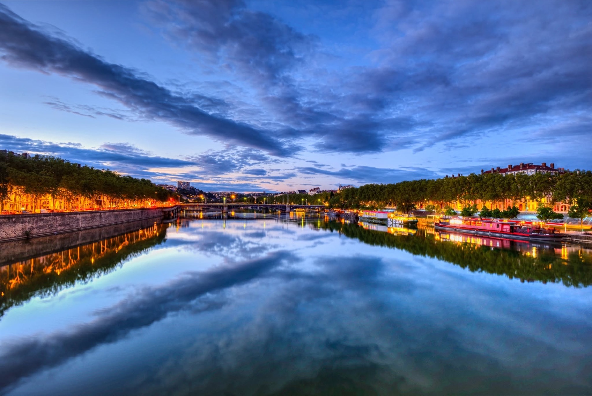 Rhône quays at blue hour with river reflections