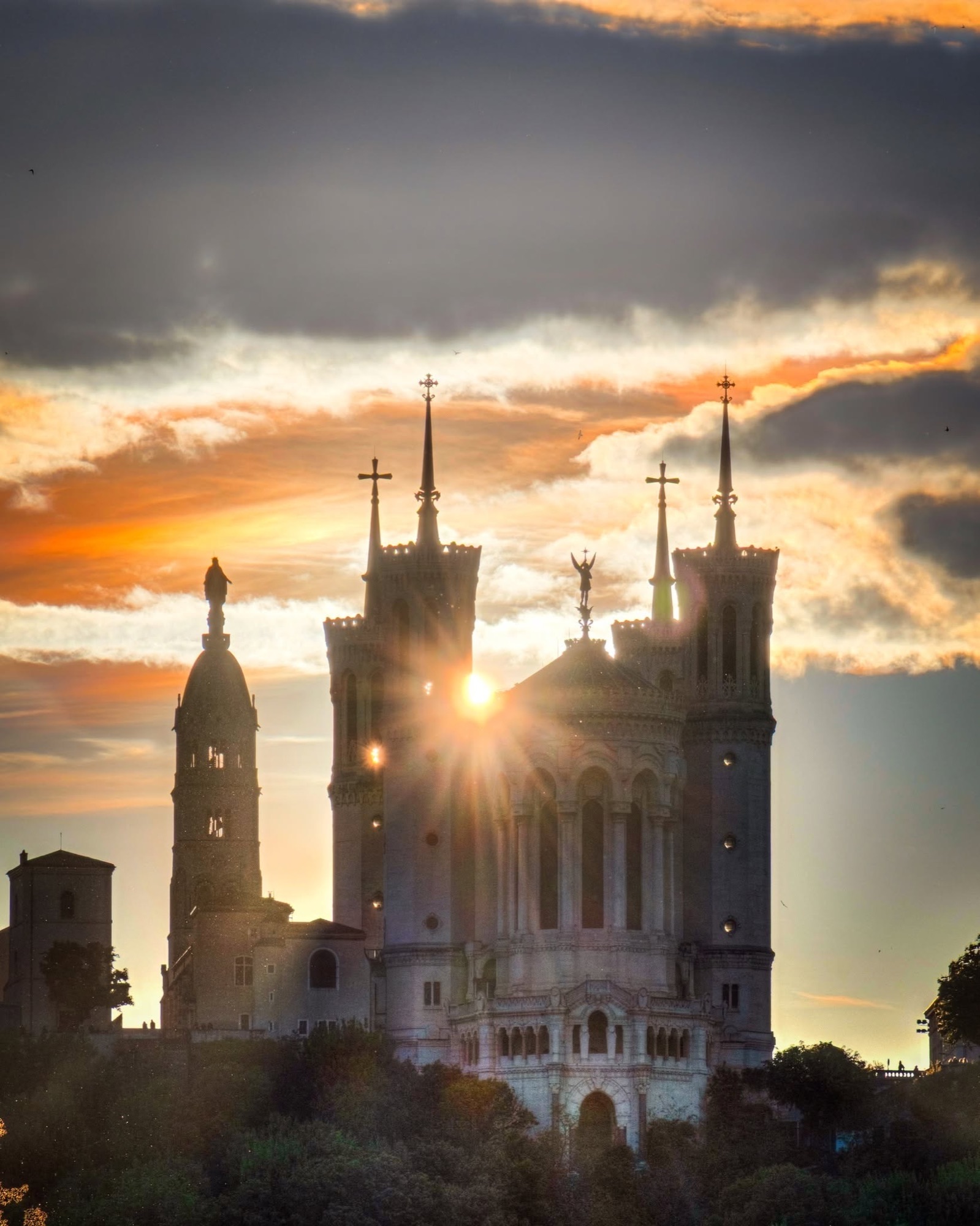 Basilique Notre-Dame de Fourvière at sunset with sunstar