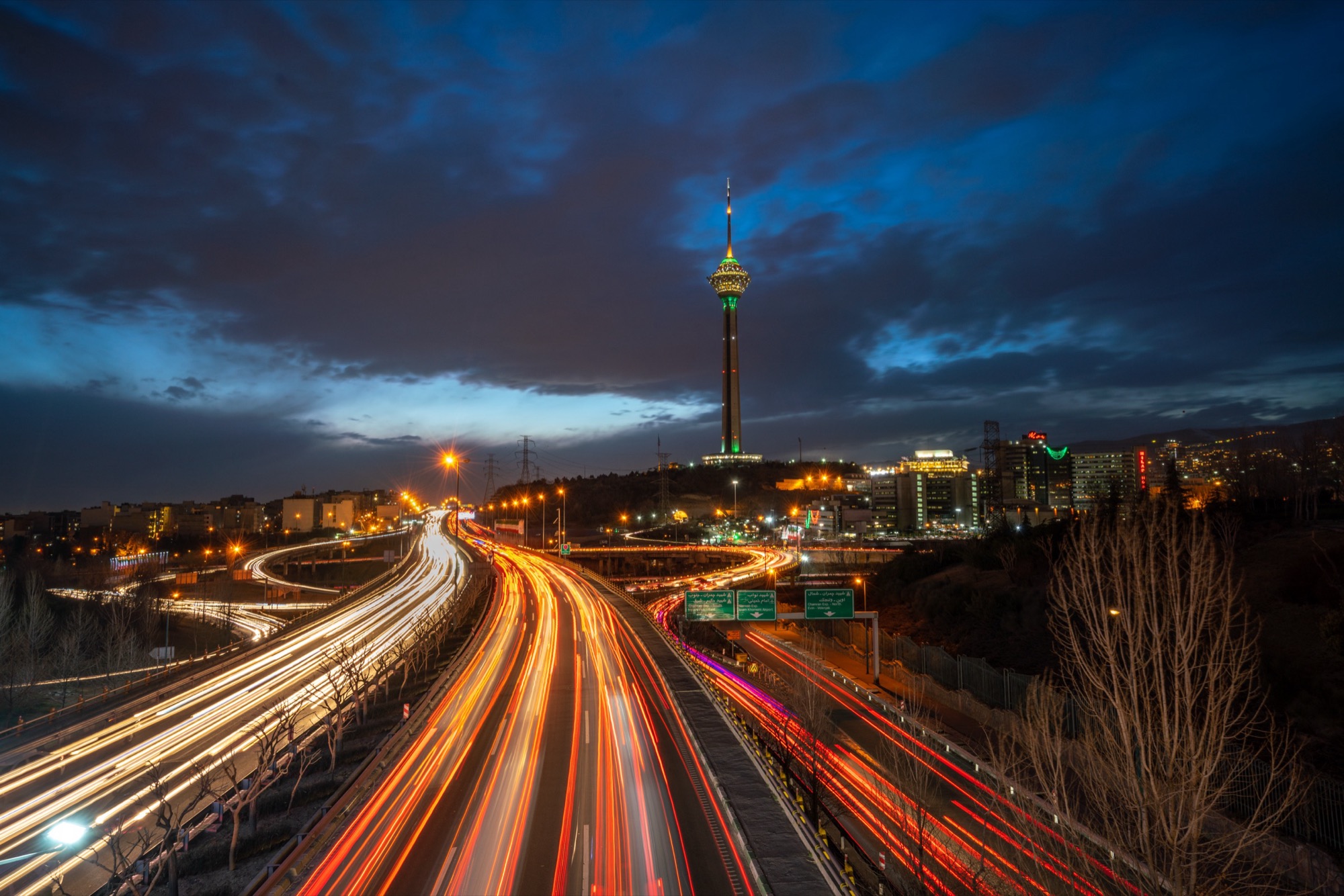 Highway light trails toward Milad Tower